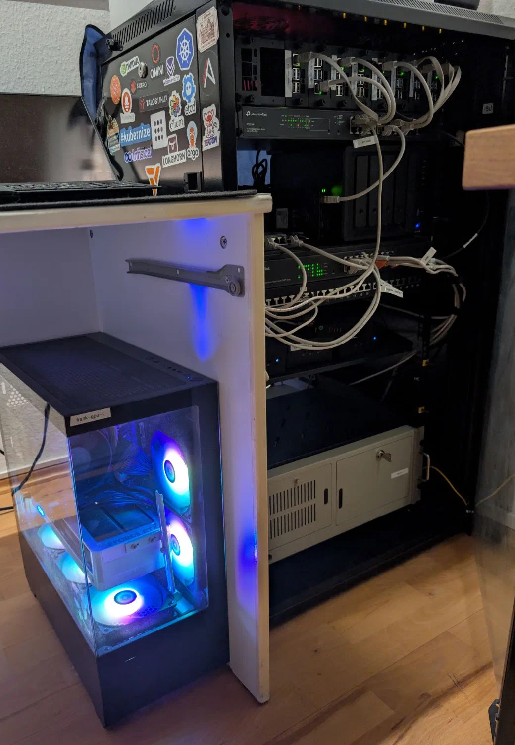 Frank cluster hardware, integrated to the rest of my homelab. The two Raspberry Pi 4s and the omni are part of the horizontal rack kit, along with a few others. The minis are hidden below the patch panel. The gpu-1 workstation stands to the left. The GPU didn't fit in a mountable 4U case so I got a gaming case with pretty lights that never turn off instead..